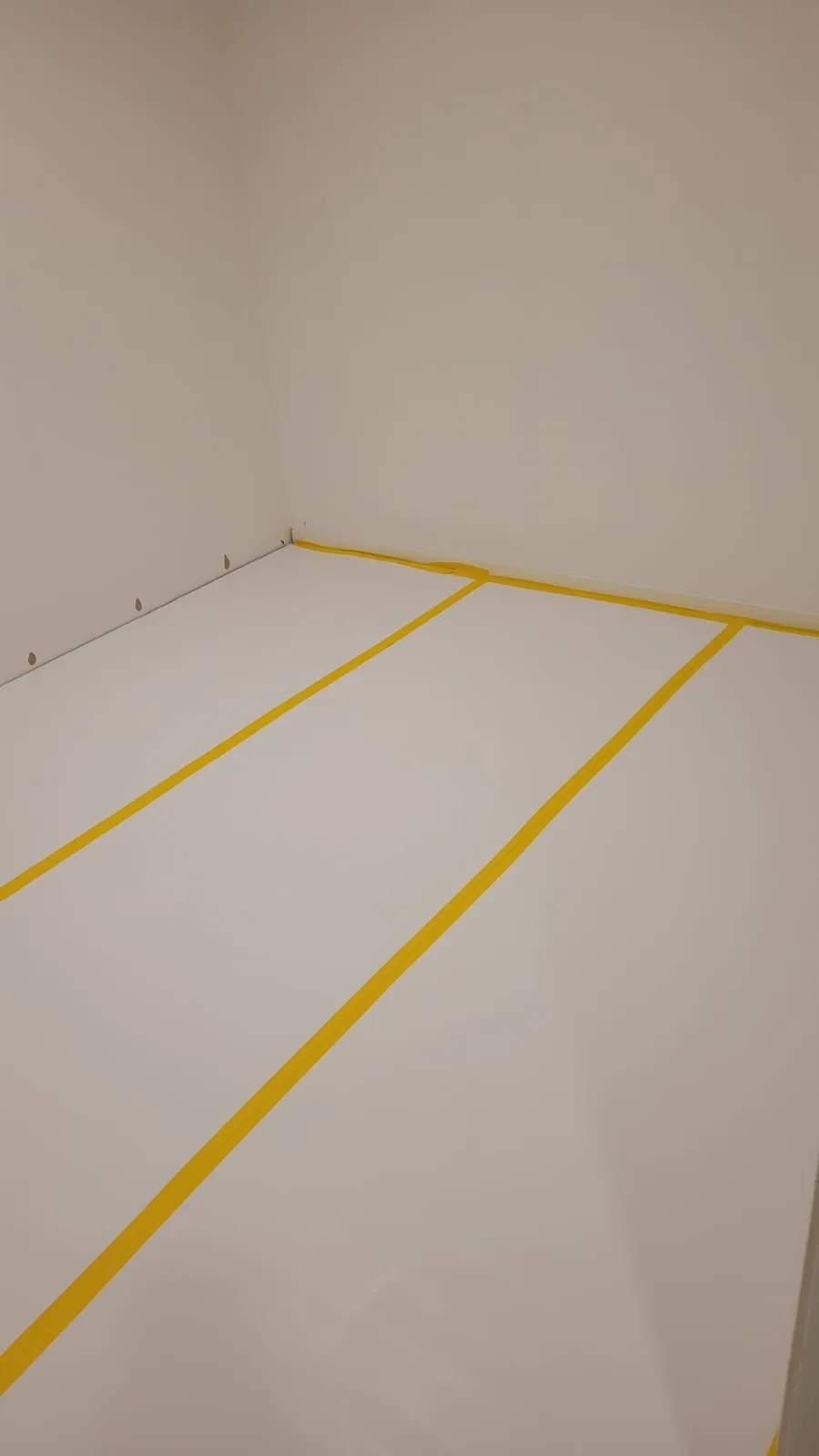 Nyanser av en golvbeläggning med gul märkning för renovering